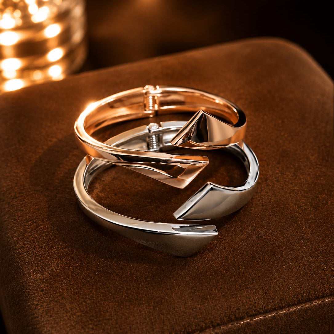 Two interlocking rings on a brown surface with a warm glow.