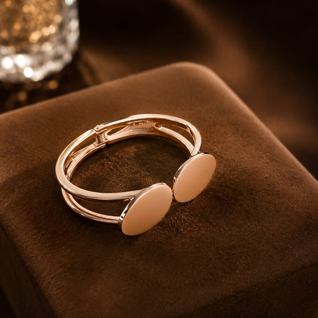 Gold ring with circular designs on a brown fabric surface