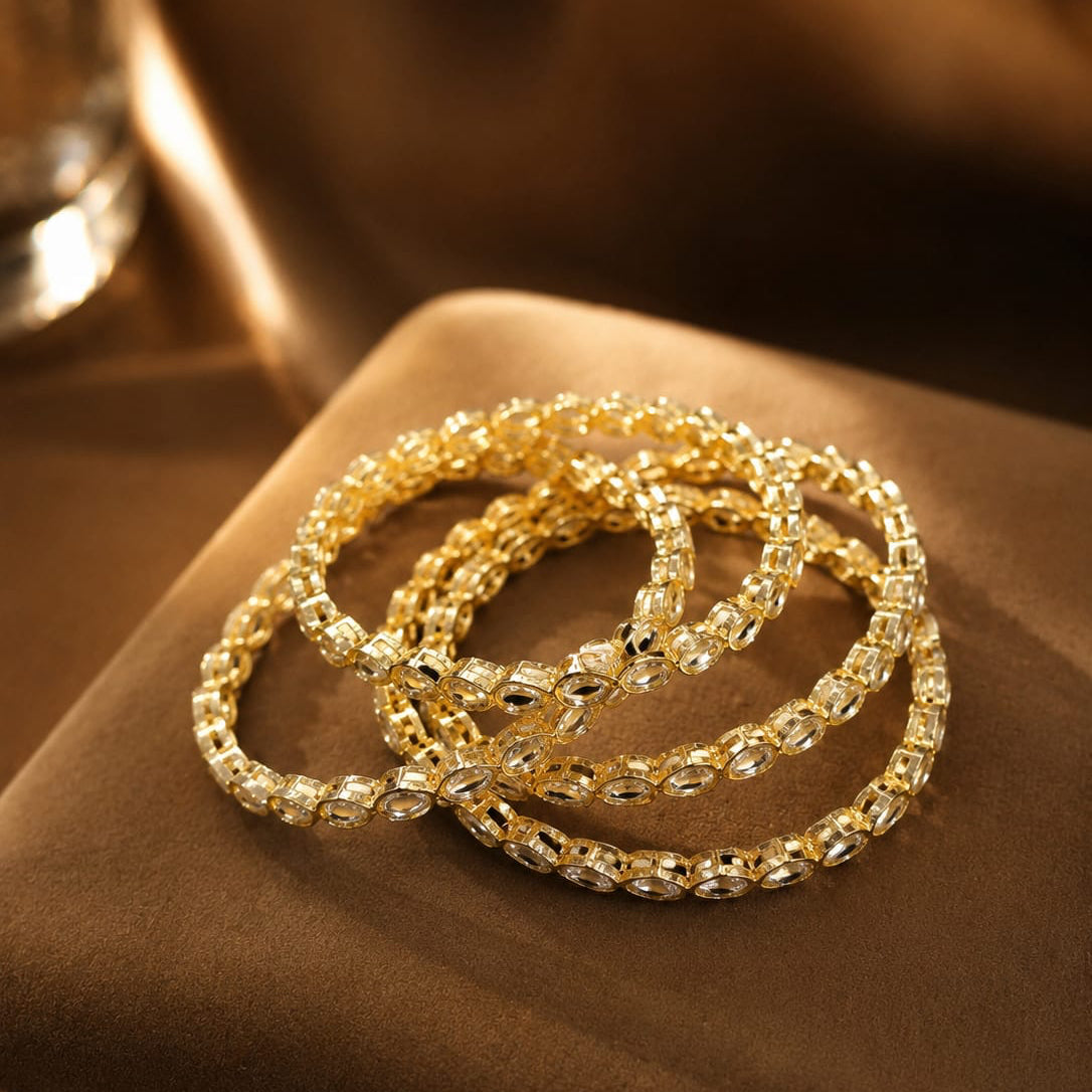 Gold bracelets on a brown surface