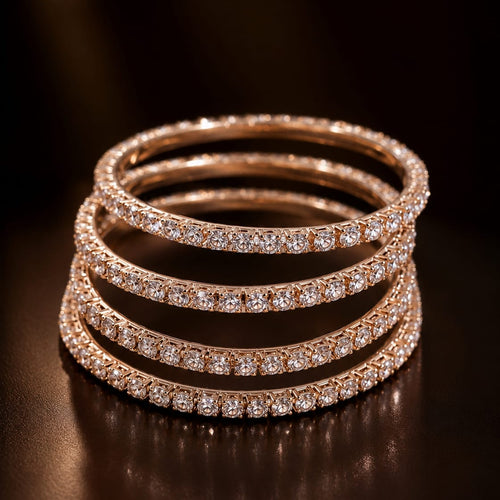 Stack of rose gold and diamond bracelets on a dark background