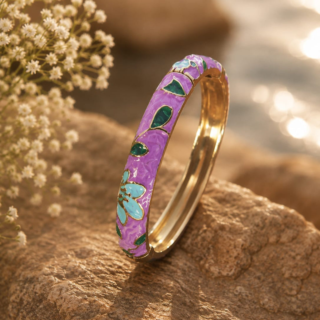 Decorative ring with floral patterns on a rock by a body of water