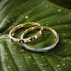 Two bangles on a green leaf with water droplets