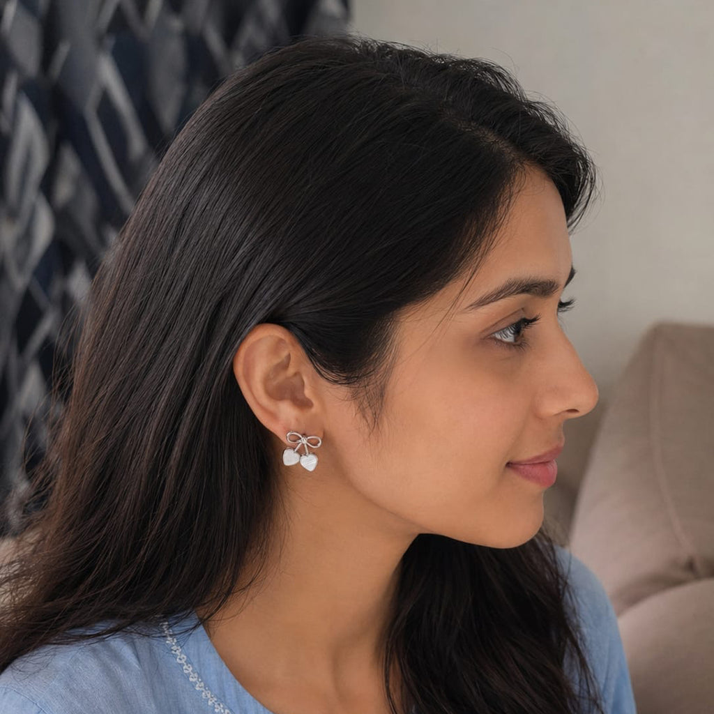 Woman wearing a blue embroidered top with a neutral background