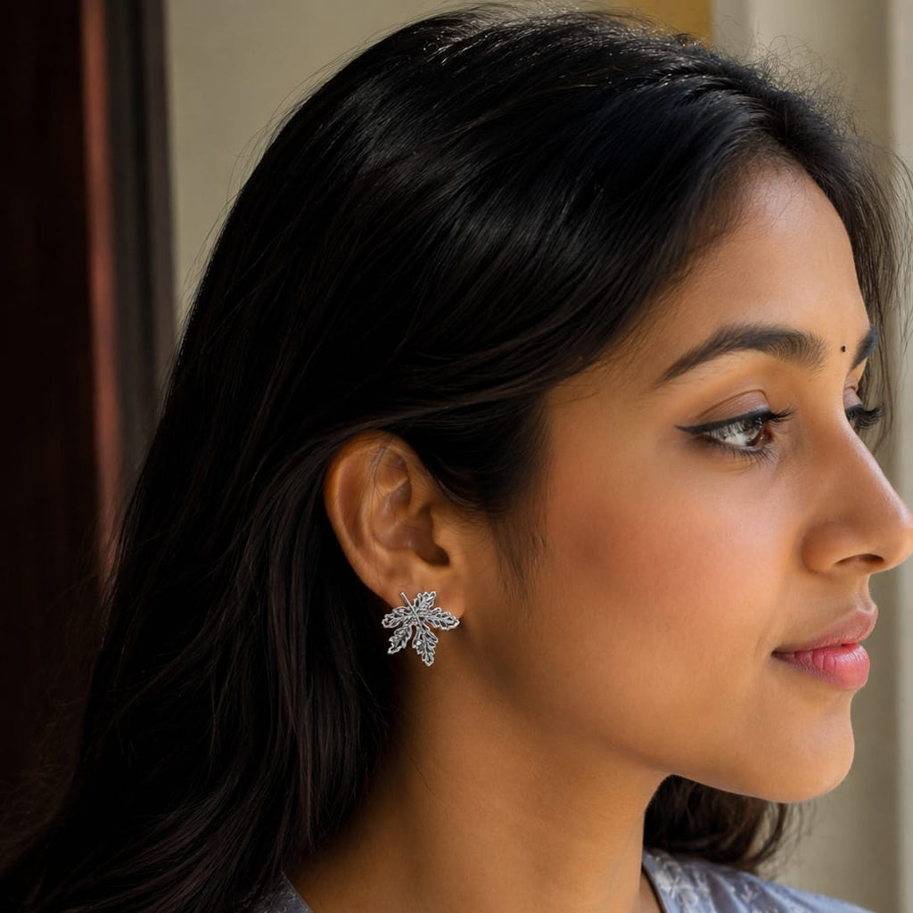 Woman wearing a floral earring with a neutral background