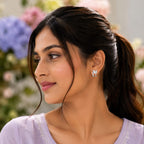 Woman wearing a light purple top with floral background