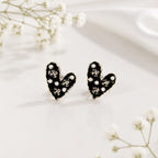 Heart-shaped earrings with black and white design on a light background