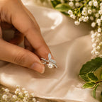 Pearl ring being held on a soft fabric background with flowers