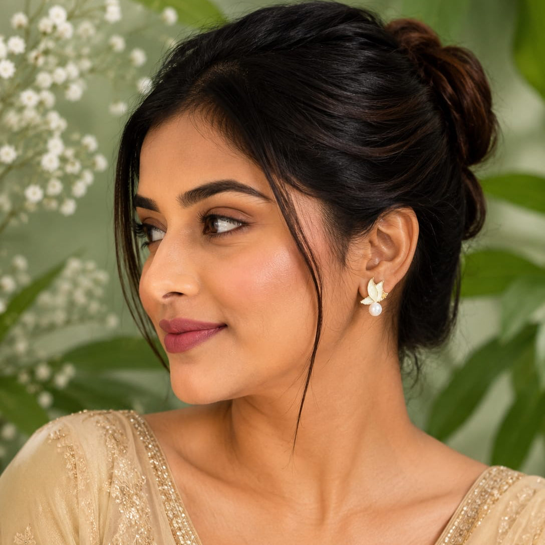 Woman wearing a beige saree with a floral background